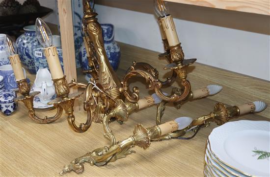 A brass five branch ceiling light and a pair of wall lights